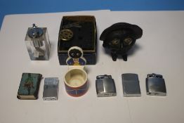 A VINTAGE SAVE AND SMILE MONEY BOX, and a quantity of cigarette lighters