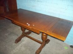A VINTAGE OAK DRAW LEAF TABLE WITH PINEAPPLE STYLE LEGS