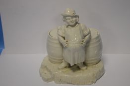 A BELLEEK FIGURE OF AN INNKEEPER WITH TWO LIDDED BARRELS WITH BLACK STAMP TO BASE, H 21 cm