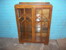 A VINTAGE DISPLAY CABINET IN WALNUT