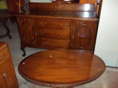 A VINTAGE SIDEBOARD AND A RETRO OVAL COFFEE TABLE