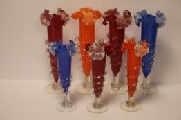 BOX OF COLOURED GLASS VASES WITH TWISTED GLASS STEMS (7 IN TOTAL)