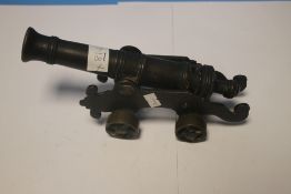 A SMALL ANTIQUE SIGNAL CANNON OF 18TH CENTURY STYLE, mounted on a brass carriage and wheels,