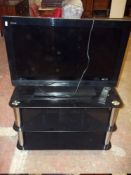 A SONY TV WITH REMOTE AND TV STAND