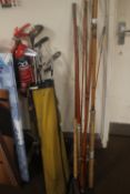 THREE VINTAGE FISHING RODS together with a collection of golf clubs
