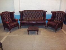 A HIGH WING BACKED LEATHER OXBLOOD FOUR PIECE CHESTERFIELD SUITE WITH QUEEN ANNE STYLE LEGS,