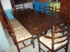 A LARGE EXTENDING OAK DINING TABLE WITH TEN CHAIRS