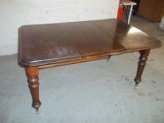 A VICTORIAN EXTENDING WIND-OUT DINING TABLE WITH ONE LEAF