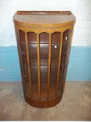 A BOWED WALNUT VINTAGE DISPLAY CABINET