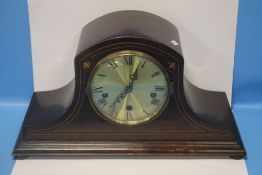 A MAHOGANY INLAID NAPOLEON HAT STYLE MANTEL CLOCK WITH KEY