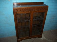 AN OAK LEADED VINTAGE BOOKCASE