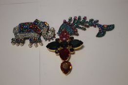 BUTLER AND WILSON, THREE BROOCHES TO INCLUDE A ARTICULATED FISH, A ELEPHANT AND A CROSS