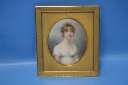 A 19TH CENTURY MINIATURE PORTRAIT OF A YOUNG LADY IN A GILT METAL FRAME, INSCRIBED TO THE BACK 