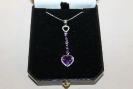 A 9 CT WHITE GOLD AND AMYTHEST NECKLACE