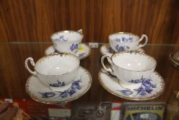 A SET OF SIX AYNSLEY GILDED BLUE AND WHITE CUPS AND SAUCERS