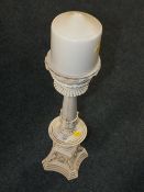 A LARGE MODERN CANDLE HOLDER AND CANDLE