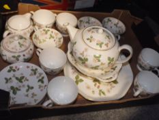 A TRAY OF WEDGWOOD WILD STRAWBERRY PATTERN CHINA TO INCLUDE A TEAPOT, CUPS AND SAUCERS ETC.