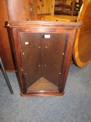 A MAHOGANY GLAZED CORNER CABINET