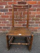 AN ANTIQUE OAK CHAIR WITH RAILS