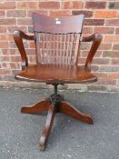 A VINTAGE OAK SWIVEL OFFICE ARMCHAIR