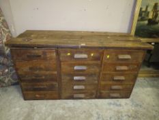 A VINTAGE BANK OF THREE DRAWERS WITH A LATER PLANK TOP H-76 CM W-149 CM