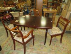 A MODERN DINING TABLE AND FOUR CHAIRS