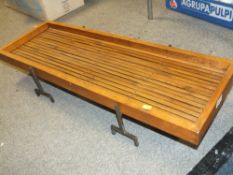 A WOODEN TABLE TOP SERVING TRAY ON METAL LEGS