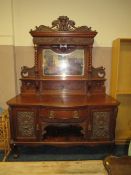 A LARGE ANTIQUE WALNUT MIRRORBACKED SIDEBOARD WITH CARVED CHERUBIC MASK DETAIL H-237 CM W-180 CM