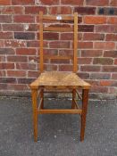 AN OAK WICKERSEAT CHAIR IN THE ARTS AND CRAFT STYLE