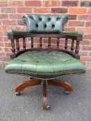 A REPRODUCTION GREEN LEATHER MAHOGANY SWIVEL ARMCHAIR