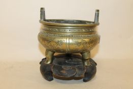 AN CHINESE BRASS CENSOR ON STAND, IMPRESSED FOUR CHARACTER MARK TO BASE, HOLE IN MAIN BODY