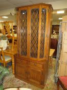A JAYCEE LARGE GLAZED AND LEADED BOOKCASE WITH ANGULAR FRONT H-199 CM W-93 CM