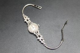 A 9 CARAT WHITE GOLD DIAMOND SET COCKTAIL WATCH, approx weigh 17.2g, Dia 1.75 cm