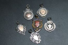 A COLLECTION OF FIVE SILVER FOB MEDALS, together with a enamelled brass example, all awarded to E