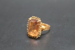 A CONTINENTAL C18 GOLD CITRINE RING, in high gallery setting, ring size P