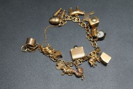 A 9CT GOLD CHARM BRACELET AND CHARMS, approx weight 28.8g