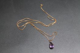A TEARDROP AMETHYST PENDANT, mount stamped 18k - not tested, on yellow metal chain, amethyst H 2 cm