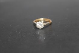 A 18CT GOLD AND PLATINUM DIAMOND SOLITAIRE RING, having an illusion set brilliant cut diamond of