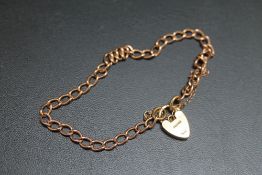 A HALLMARKED 9 CARAT GOLD PADLOCK, attached to hallmarked rose colour bracelet, approx weight 6.8g