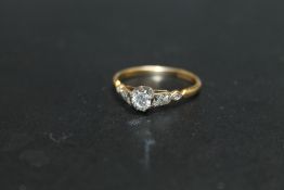 AN 18CT AND PLATINUM DIAMOND SOLITAIRE RING, set with a brilliant cut diamond of and estimated