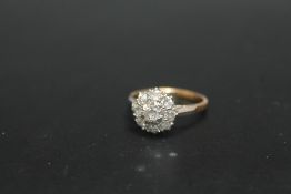 AN 18CT AND PLATINUM DIAMOND CLUSTER RING, set with nine diamonds totalling an estimated 1 carat,