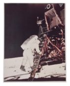 Buzz Aldrin descends the steps of ladder [large format], Apollo 11, July 1969