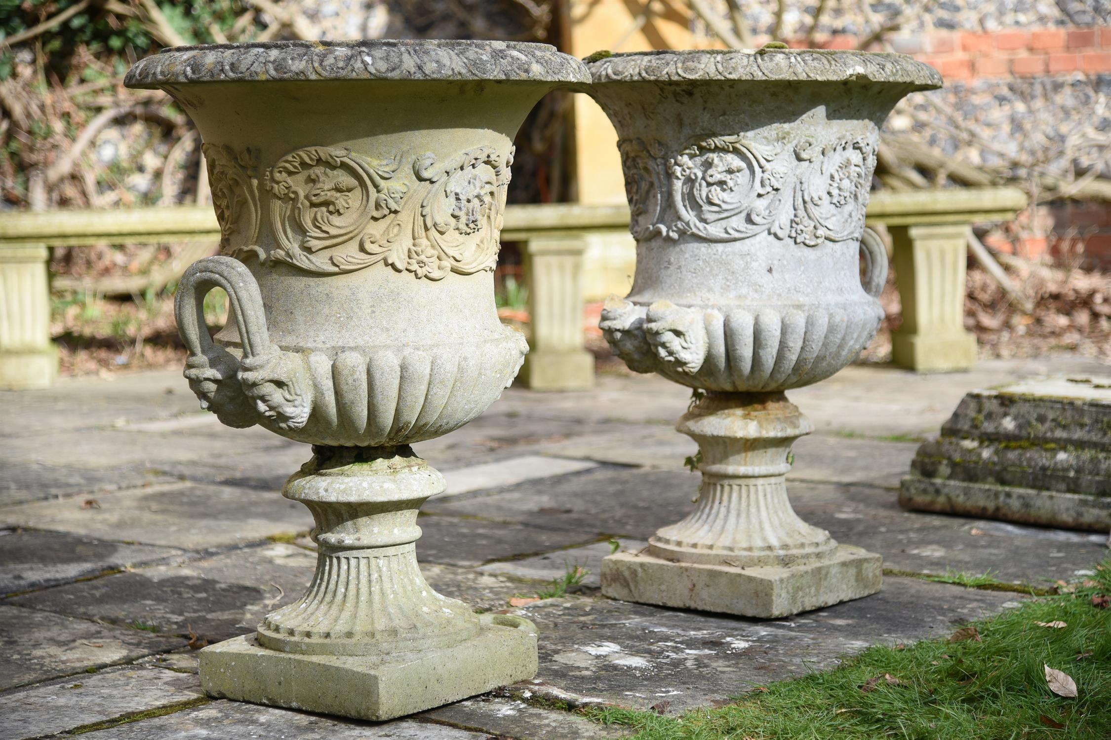 A pair of stone composition campana urns