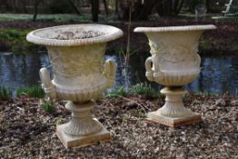 A pair of Victorian white painted cast iron campana urns