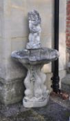 A sculpted stone figural wall fountain