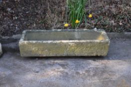A carved sandstone or limestone garden trough or basin