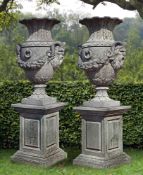 A pair of impressive carved limestone urns
