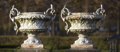 A large pair of French white painted cast iron twin handled urns