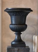 A cast iron garden urn