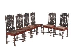 A set of six Victorian stained and carved oak dining chairs in Carrollian style